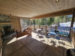Enjoy clubhouse amenities including a cozy fireplace and outdoor seating overlooking the pool.